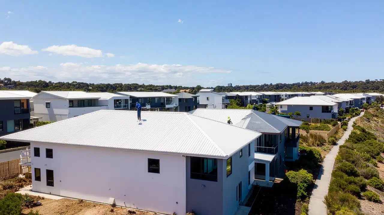 Aerial view of white-roofed houses in a residential development